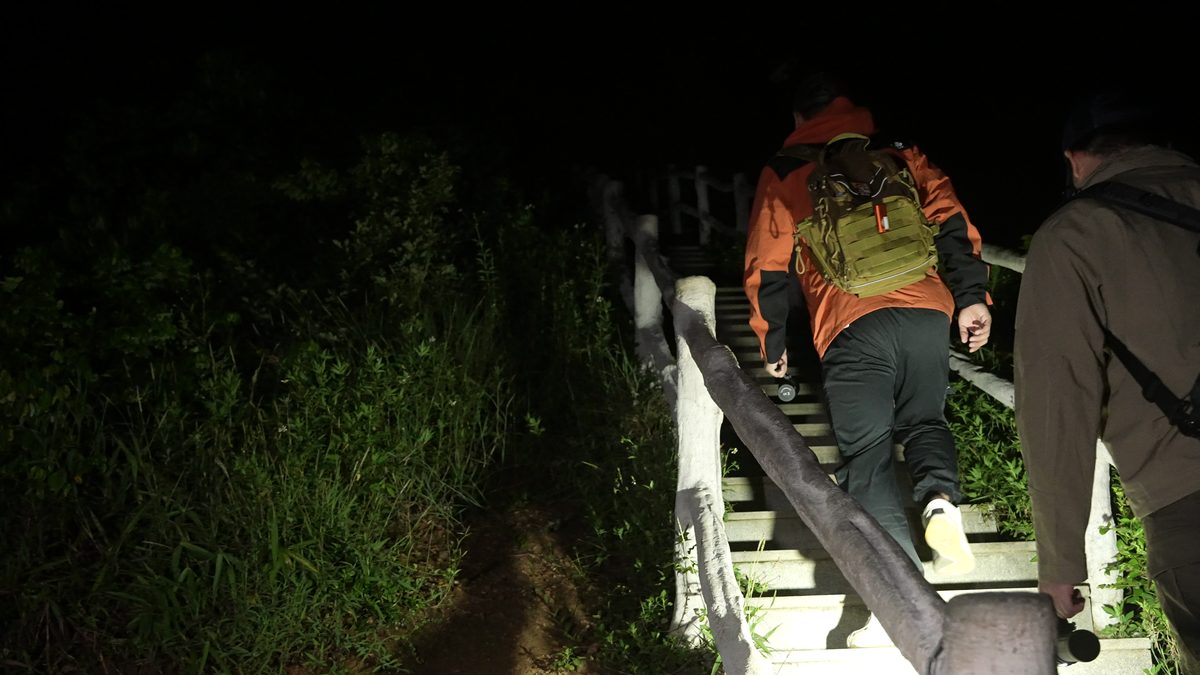 Explorers climbing illuminated steps at night with the X80GT 3